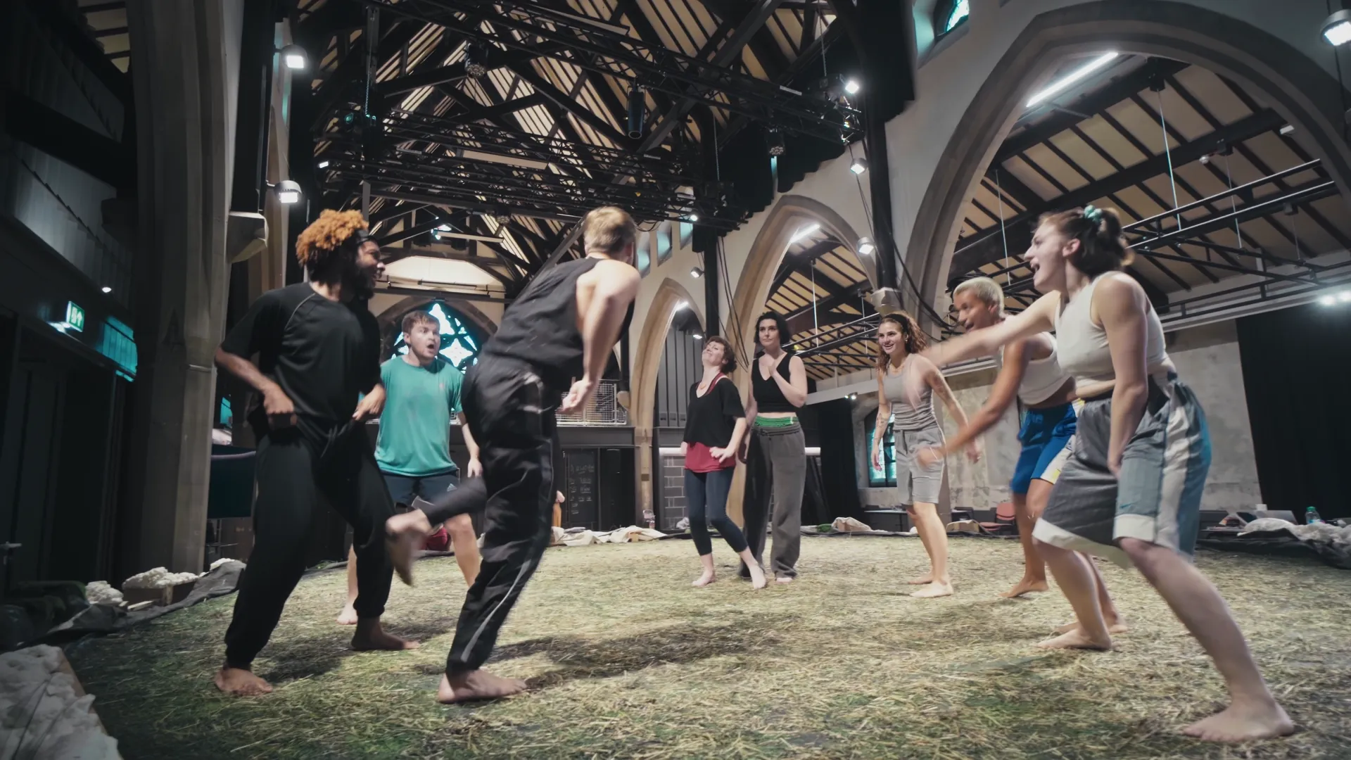 Wide rehearsal-room frame — full Fran Wen OLION cast working in the timber-beamed Welsh rehearsal hall.