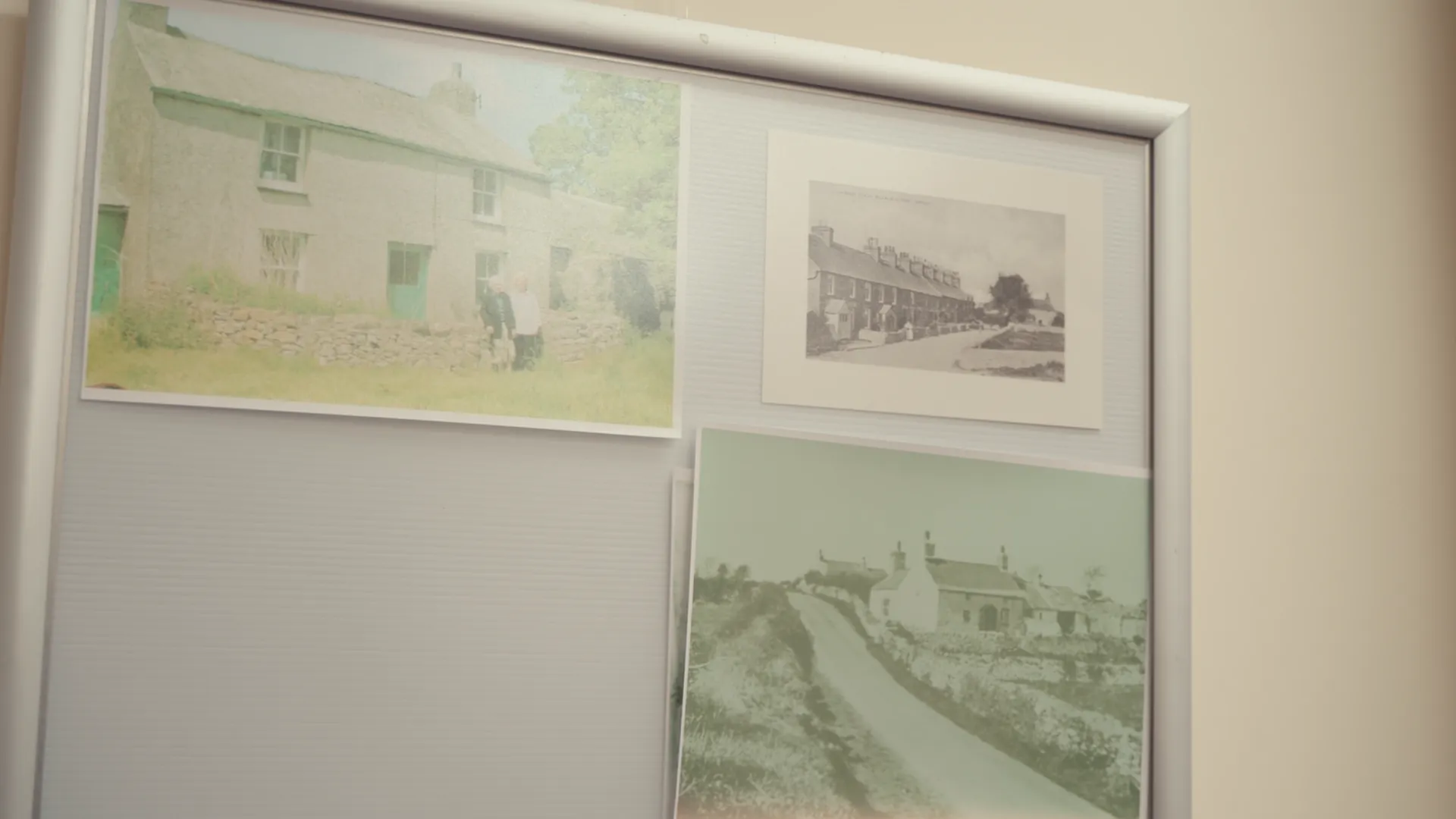 Historical photographs of Llanbedrgoch village houses on a heritage display board — Ffrindiau Llanbedrgoch local history work, Anglesey.